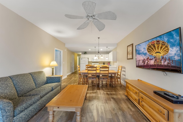 living room featuring ceiling fan and dark hardwood / wood-style flooring