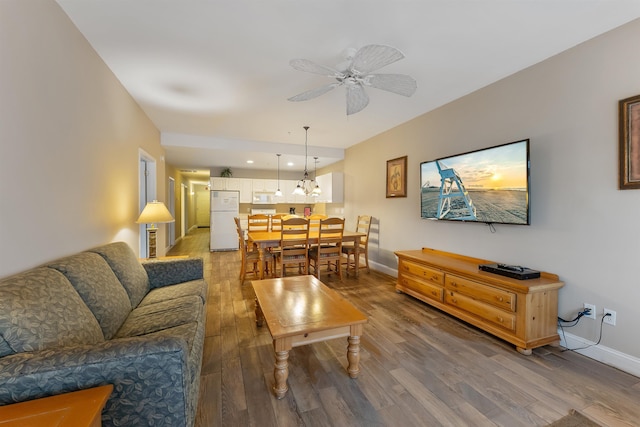 living room featuring hardwood / wood-style flooring and ceiling fan