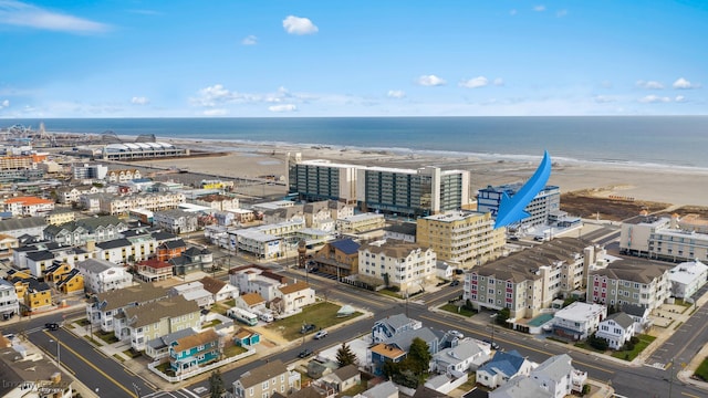 bird's eye view with a water view and a beach view