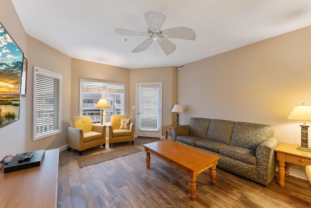 living room with hardwood / wood-style flooring and ceiling fan