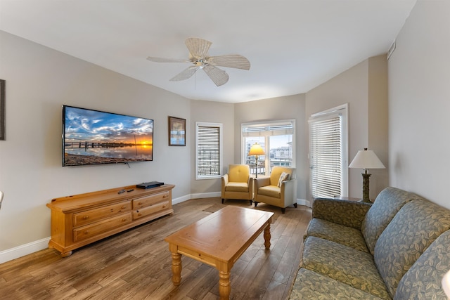 living room featuring ceiling fan and hardwood / wood-style floors