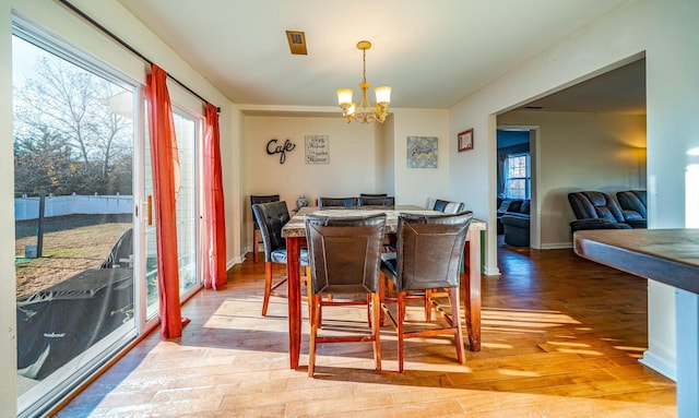 dining room featuring wood-type flooring and an inviting chandelier