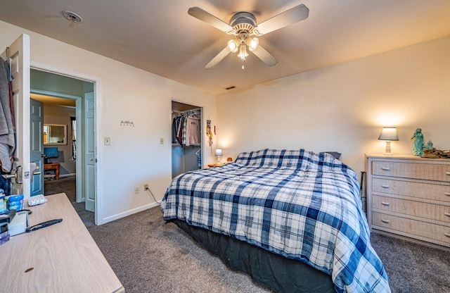 carpeted bedroom featuring ceiling fan, a walk in closet, and a closet