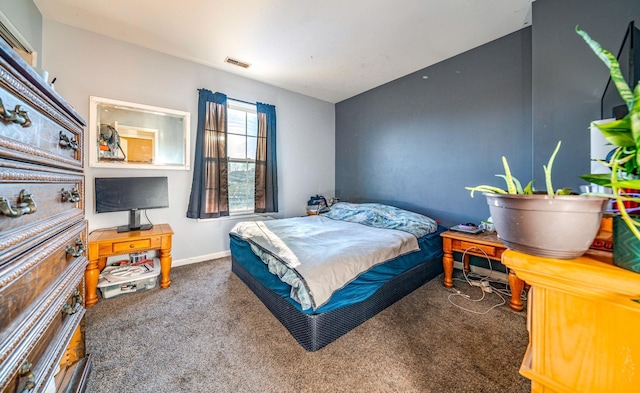 bedroom with dark colored carpet