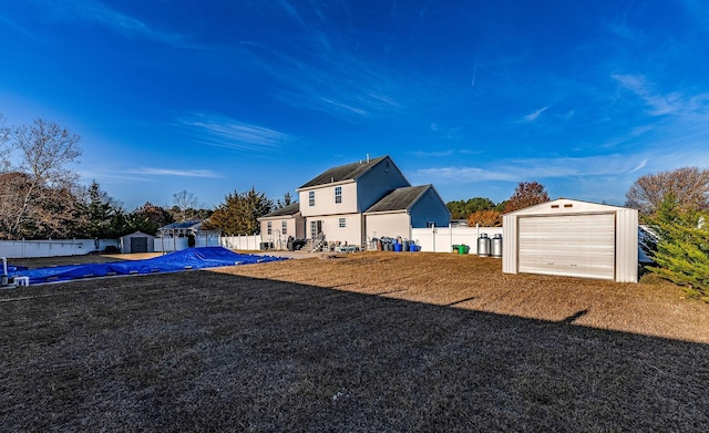 view of yard with a garage and an outdoor structure