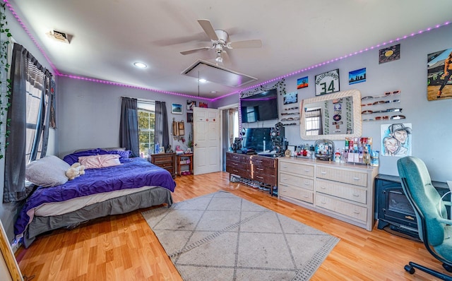 bedroom with light hardwood / wood-style flooring and ceiling fan