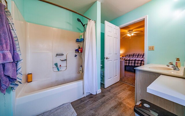 full bathroom featuring shower / tub combo, vanity, ceiling fan, hardwood / wood-style floors, and toilet