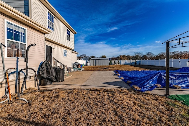 view of yard featuring a patio area and a storage shed