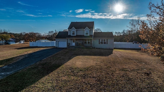 view of front of house with a porch, a garage, and a front lawn