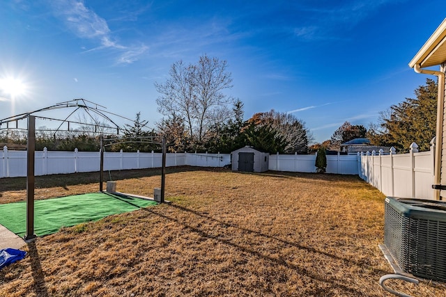 view of yard with a gazebo, central AC unit, and a storage shed