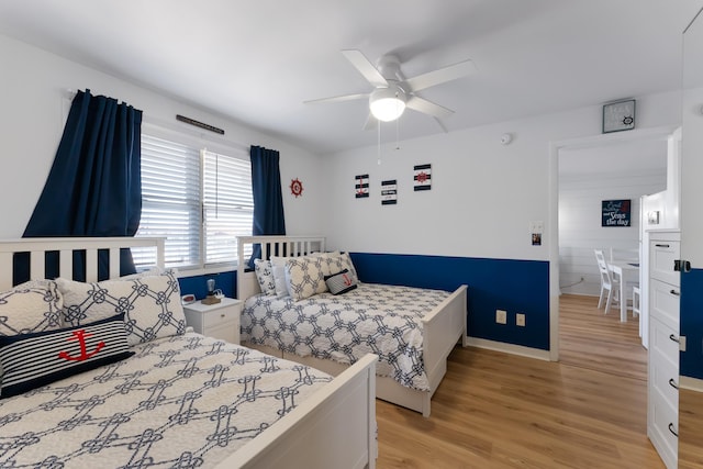 bedroom with ceiling fan and light wood-type flooring