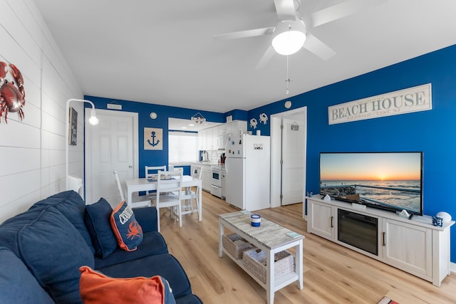 living room with ceiling fan and light wood-type flooring