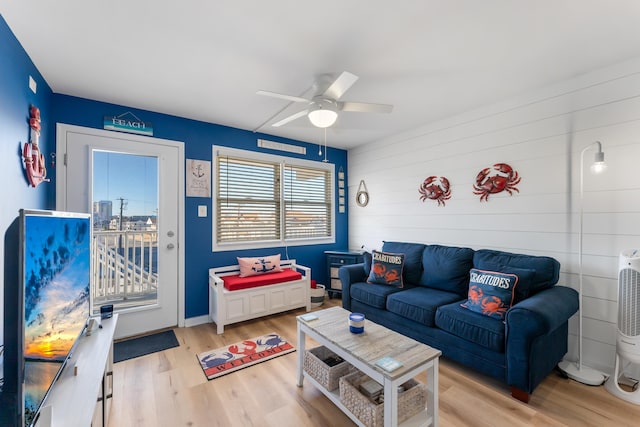 living room with light hardwood / wood-style flooring and ceiling fan