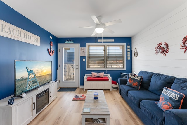 living room featuring ceiling fan and light wood-type flooring