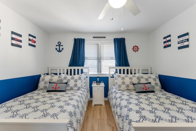 bedroom with ceiling fan and light wood-type flooring