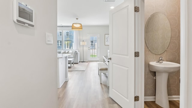 212 Bentz Ave, Villas, NJ 08251 - corridor with light wood finished floors, baseboards, and a sink