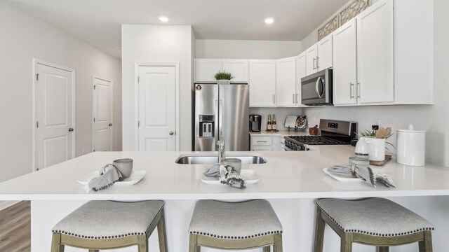 212 Bentz Ave, Villas, NJ 08251 - kitchen with appliances with stainless steel finishes, a kitchen breakfast bar, light countertops, a peninsula, and a sink