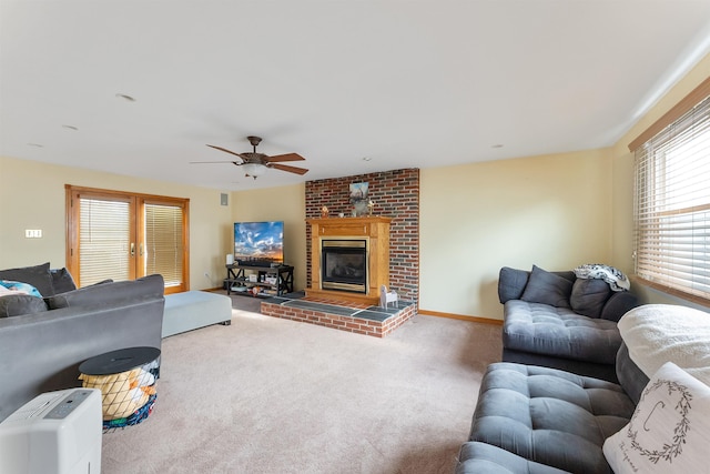 carpeted living room featuring ceiling fan and a brick fireplace