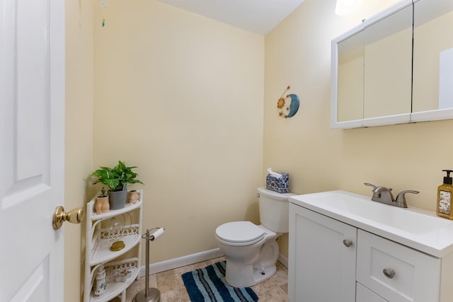 bathroom featuring vanity, tile patterned floors, and toilet