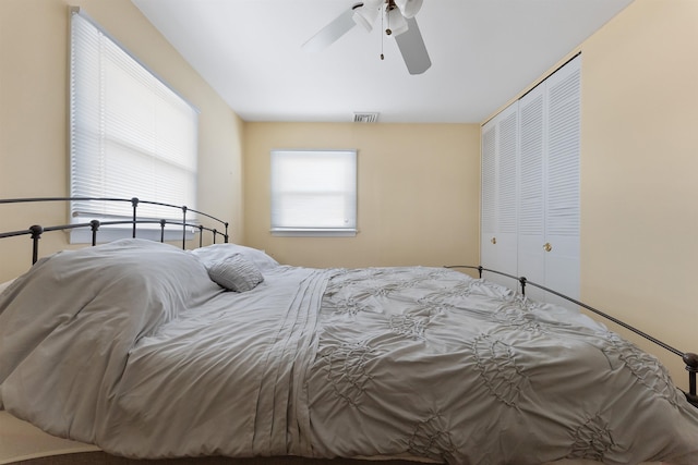 bedroom with ceiling fan and a closet