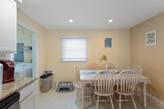 tiled dining area with separate washer and dryer