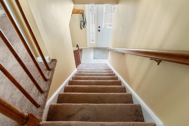 staircase featuring tile patterned floors