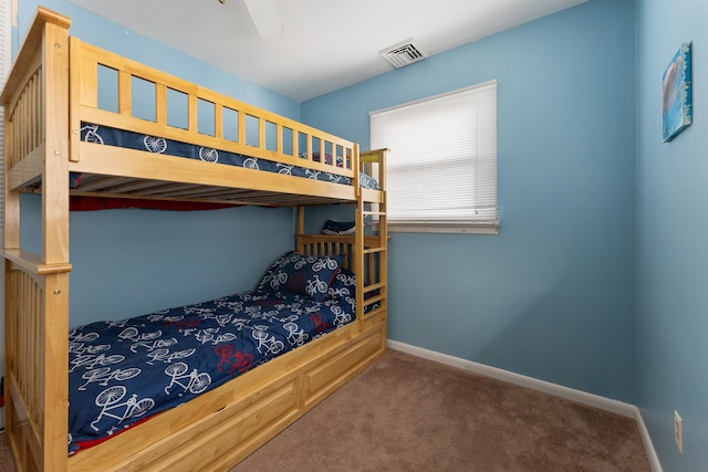 bedroom featuring dark carpet and ceiling fan