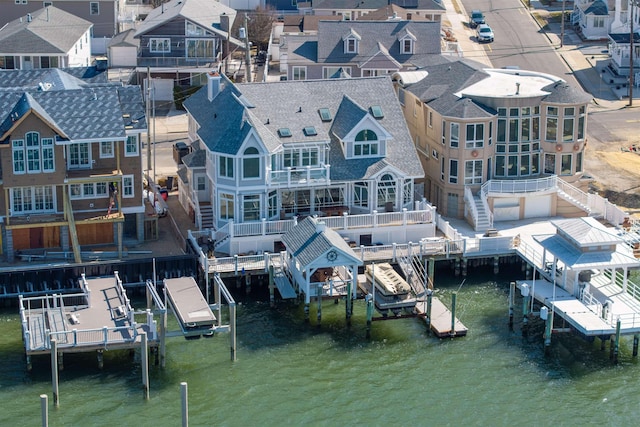 birds eye view of property featuring a water view and a residential view