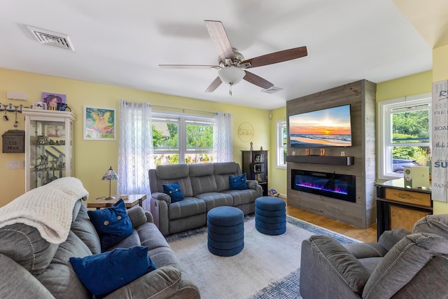 25 N 12th St, Del Haven, NJ 08251 - living area with a fireplace, wood finished floors, plenty of natural light, and a ceiling fan