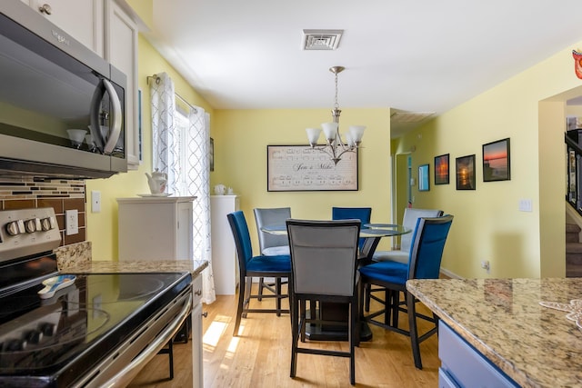 25 N 12th St, Del Haven, NJ 08251 - dining room with a chandelier and light wood finished floors