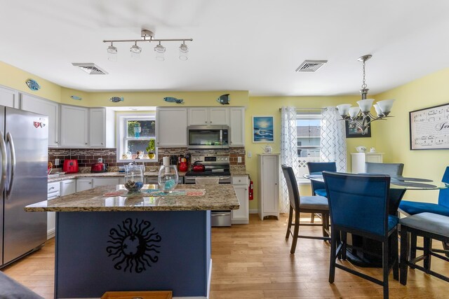 25 N 12th St, Del Haven, NJ 08251 - kitchen with stainless steel appliances, a chandelier, plenty of natural light, and light wood finished floors