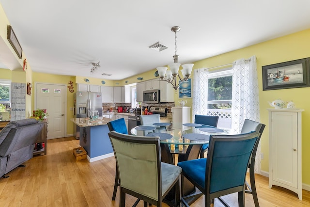 25 N 12th St, Del Haven, NJ 08251 - dining room with a chandelier, light wood-type flooring, and plenty of natural light