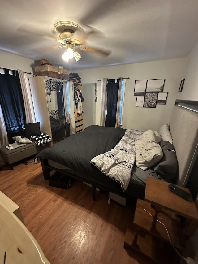 bedroom with hardwood / wood-style flooring and ceiling fan