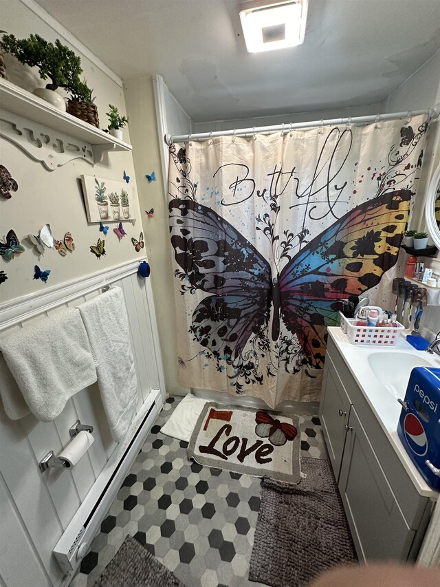 bathroom with vanity, a shower with shower curtain, and a baseboard heating unit