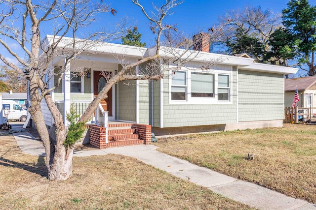 view of front of house with a front yard and a porch