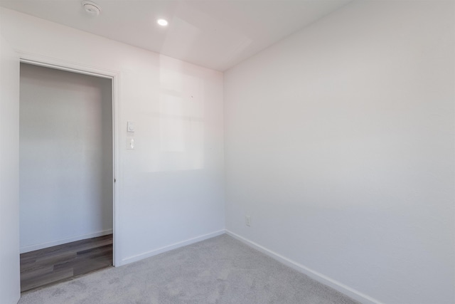 spare room featuring light colored carpet