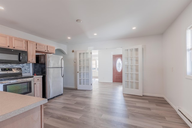 kitchen featuring french doors, a baseboard radiator, appliances with stainless steel finishes, light brown cabinetry, and decorative backsplash