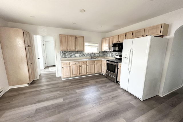 kitchen with sink, white fridge with ice dispenser, light brown cabinets, stainless steel electric range, and decorative backsplash