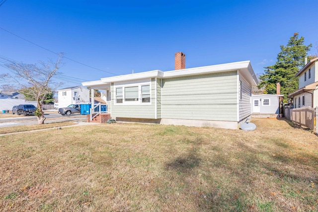 rear view of property featuring a yard