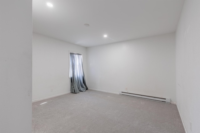 unfurnished room with light colored carpet and a baseboard radiator