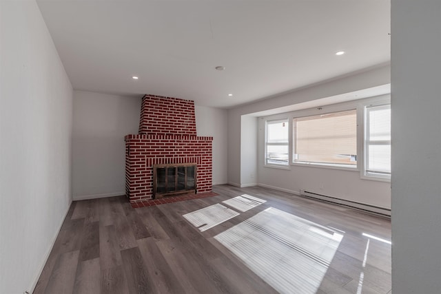 unfurnished living room with a fireplace, dark hardwood / wood-style flooring, and baseboard heating