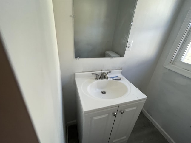 bathroom featuring vanity and toilet