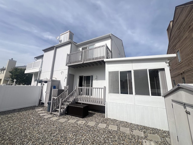 rear view of property with a balcony
