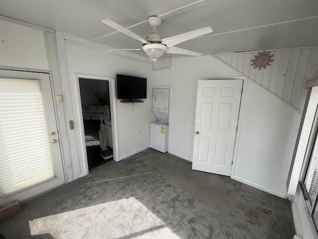 unfurnished bedroom with dark carpet, a ceiling fan, and baseboards