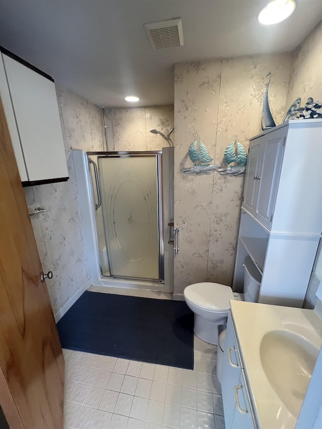 full bathroom featuring tile patterned flooring, a stall shower, vanity, wallpapered walls, and toilet