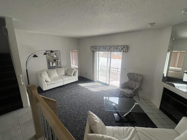 living area with a textured ceiling and stairs