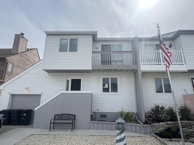 back of property featuring a balcony