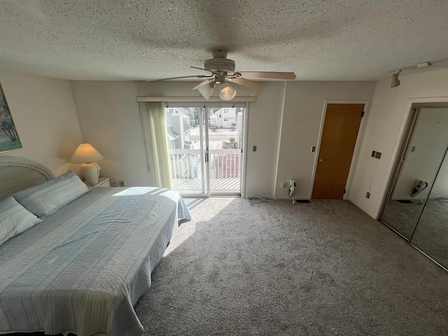 carpeted bedroom featuring access to exterior, a textured ceiling, and a ceiling fan