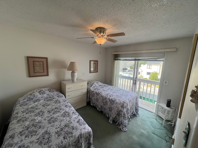 carpeted bedroom featuring access to outside, a textured ceiling, and a ceiling fan