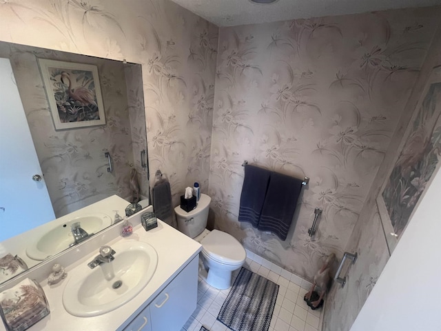 bathroom with tile patterned flooring, toilet, vanity, and wallpapered walls
